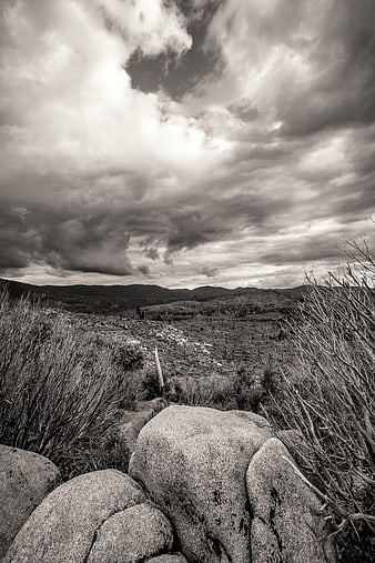 Dramatic Black and White Landscape with Boulders and Clouds