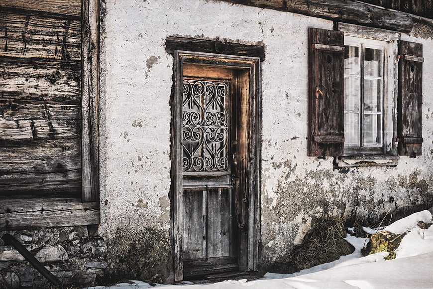 Weathered Rustic Farmhouse Door And Window In Winter Snow