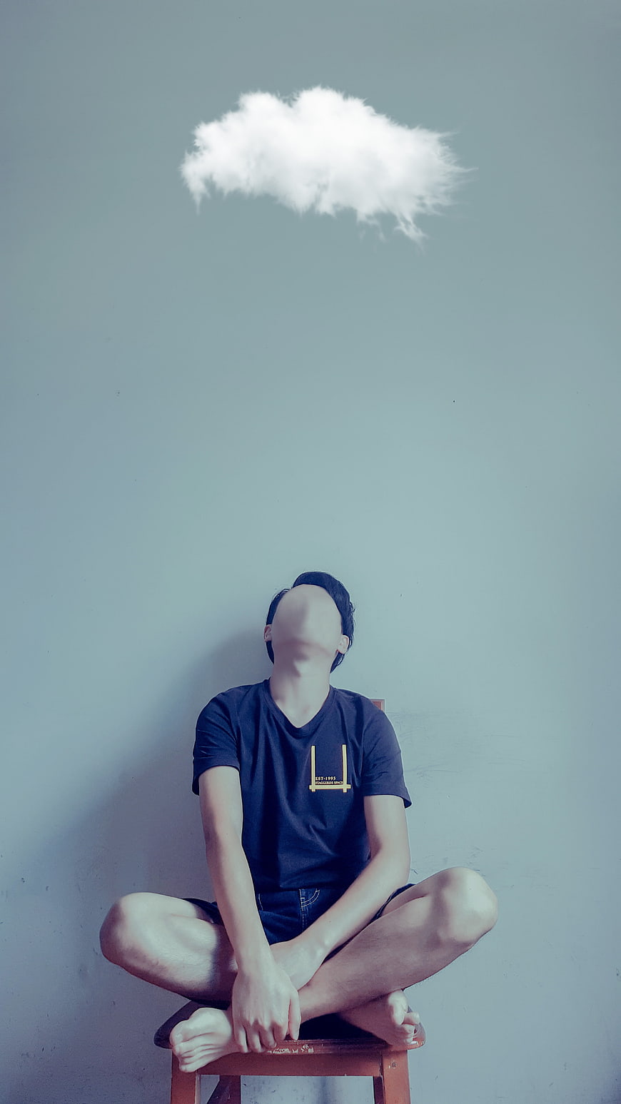 Anonymous man sitting with cloud above head