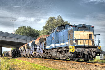 Blue freight train locomotive on railway tracks