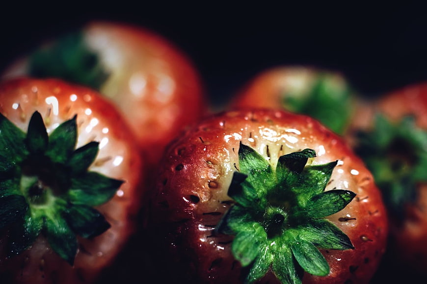 Close-up of Fresh Red Strawberries with Green Leaves