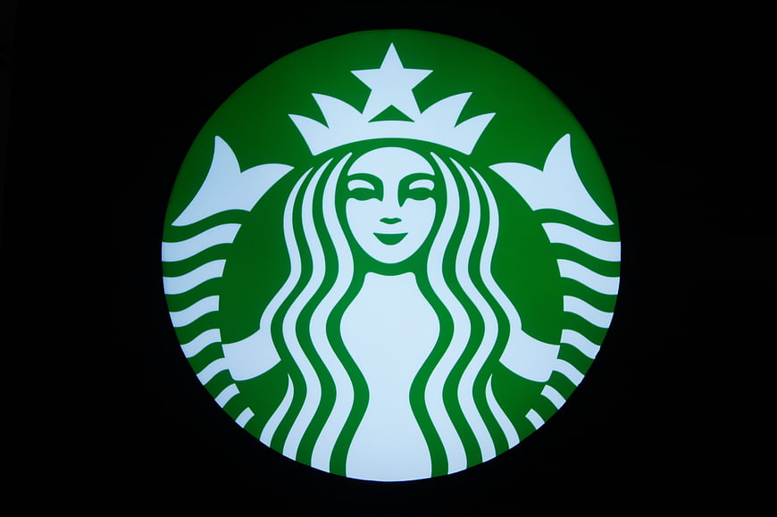 Illuminated Starbucks Logo on Black Background