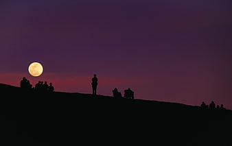 Silhouettes of People Watching Full Moon on Hill at Dusk