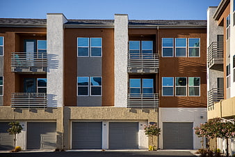 Modern brown and gray apartment building facade with balconies