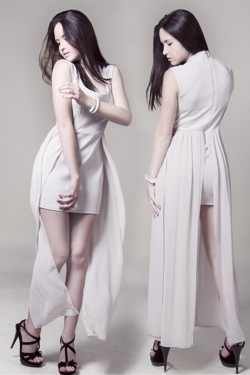 Fashion Model in White Sleeveless Dress with High Slit