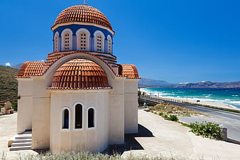 Greek Orthodox Church with Red Dome by the Sea