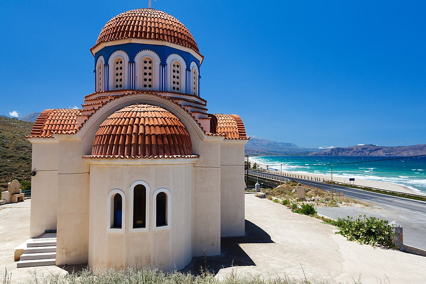 Greek Orthodox Church with Red Dome by the Sea