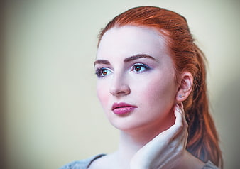 Studio Portrait of Young Woman with Red Hair and Makeup