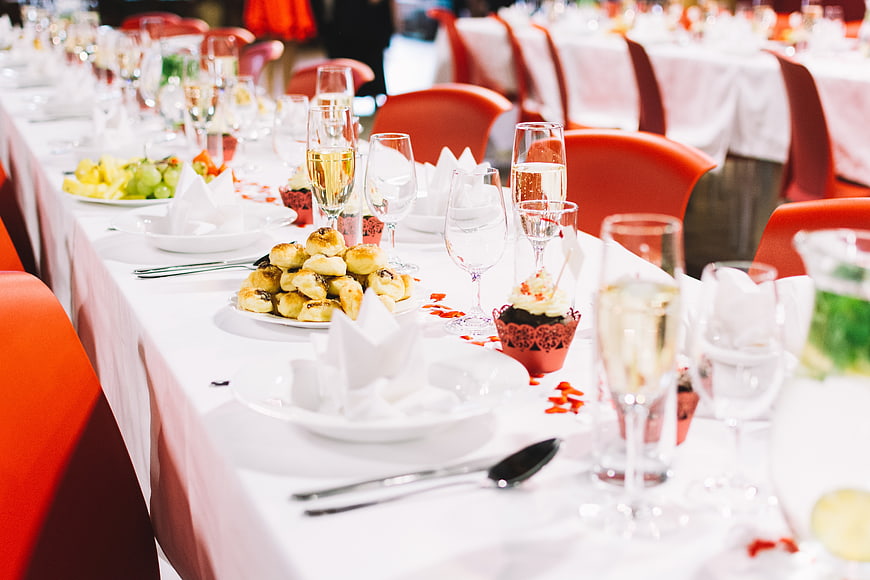 Elegant wedding reception table setting with food and drinks