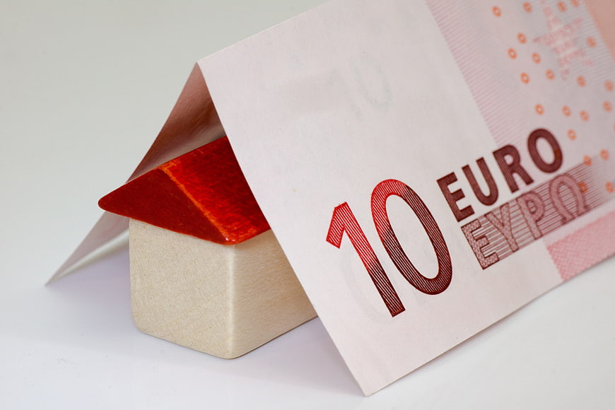 10 Euro Banknote Covering Small Wooden House Model