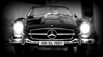 Front view of a 1957 Mercedes-Benz 300 SL classic car in black and white