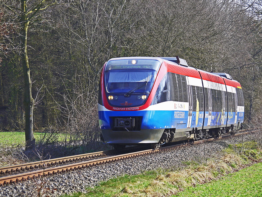Blue and red regional train on rural tracks