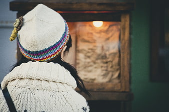 Woman in Knit Beanie Looking at Wooden Display Case