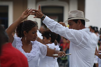 Couple dancing traditional Danzon in white attire