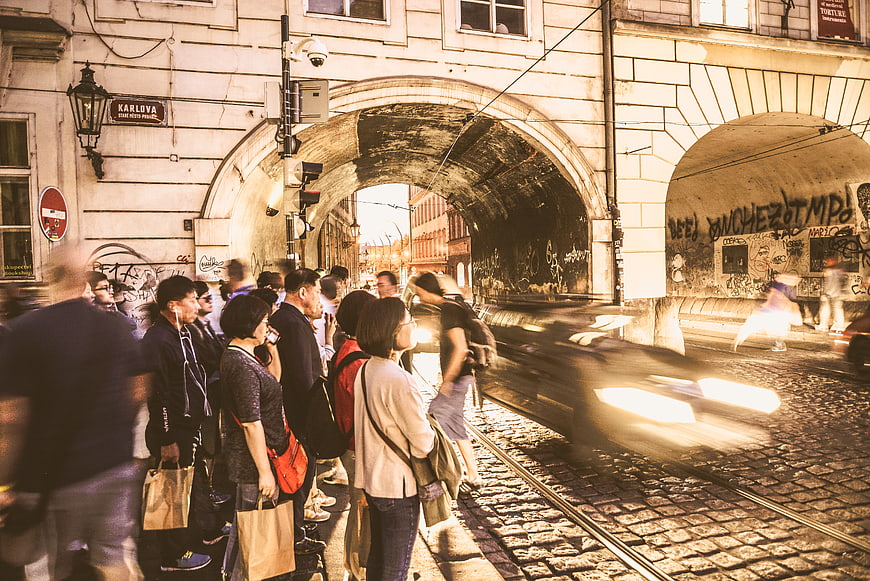 Crowd waiting at tram crossing in Prague