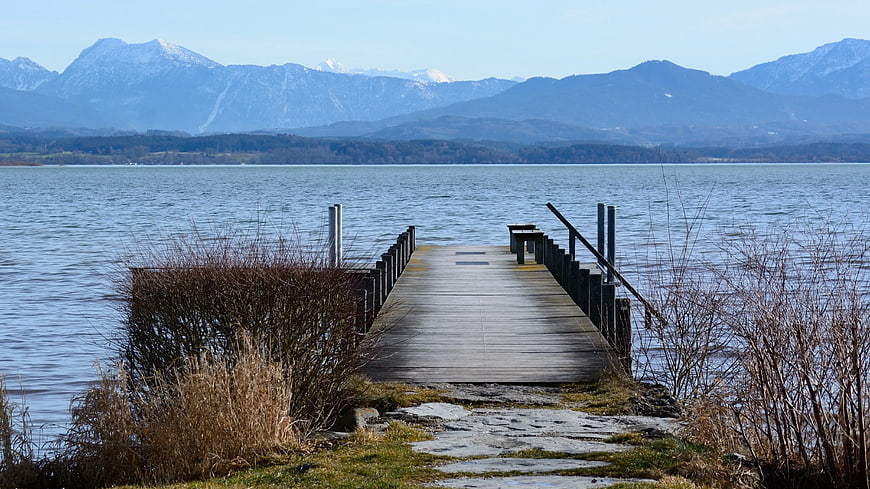 Wooden Dock Extending into Lake with Snowy Mountains