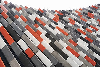 Modern geometric building facade with orange and gray panels