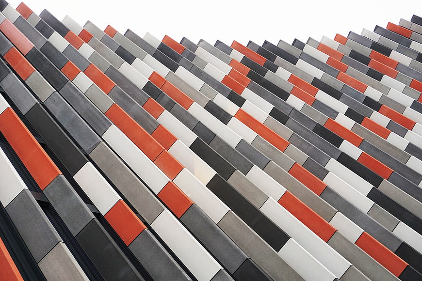 Modern geometric building facade with orange and gray panels