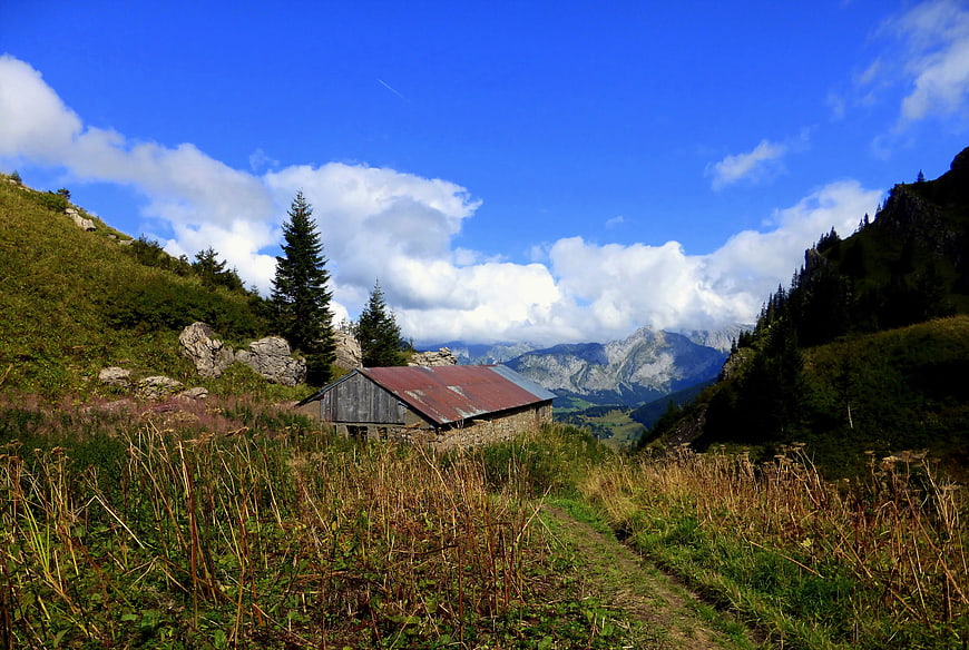 Rustic Mountain Cabin in Alpine Landscape with Blue Sky