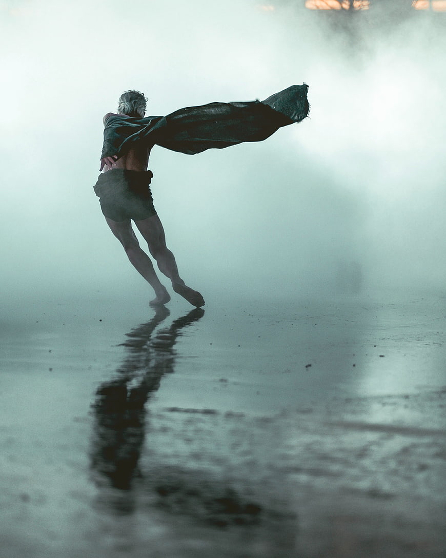 Man Running with Cape in Foggy Atmospheric Setting