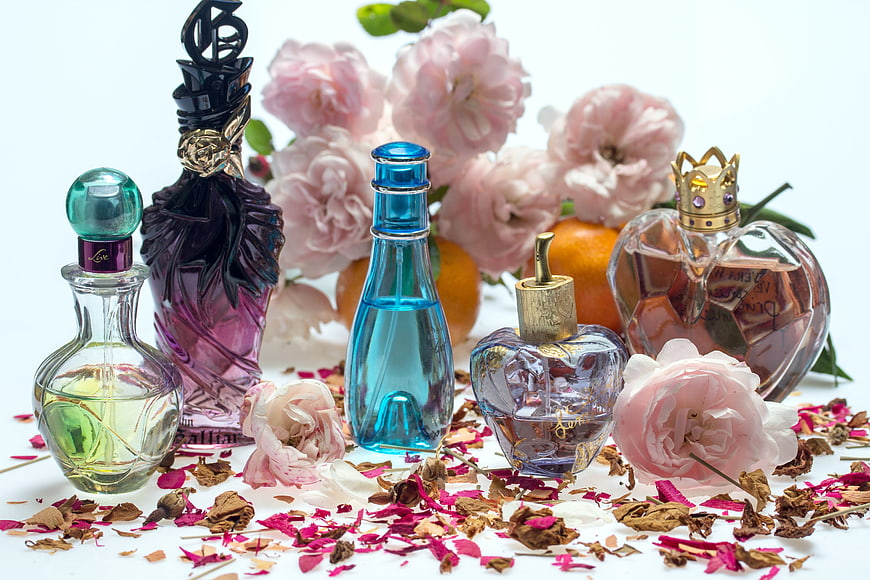 Luxury perfume bottles with pink roses and dried petals