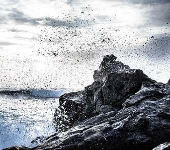 Dramatic Sea Spray Hitting Dark Coastal Rocks