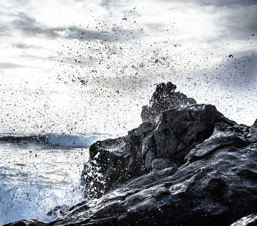 Dramatic Sea Spray Hitting Dark Coastal Rocks
