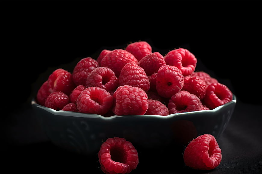 Fresh Raspberries in a Dark Ceramic Bowl