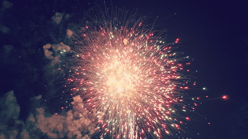 Golden Fireworks Bursting Against Dark Night Sky