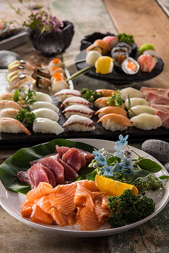 Assorted Sushi Platter With Salmon Sashimi And Tuna On Rustic Table