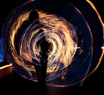 Silhouette of Person Spinning Steel Wool Fire at Night