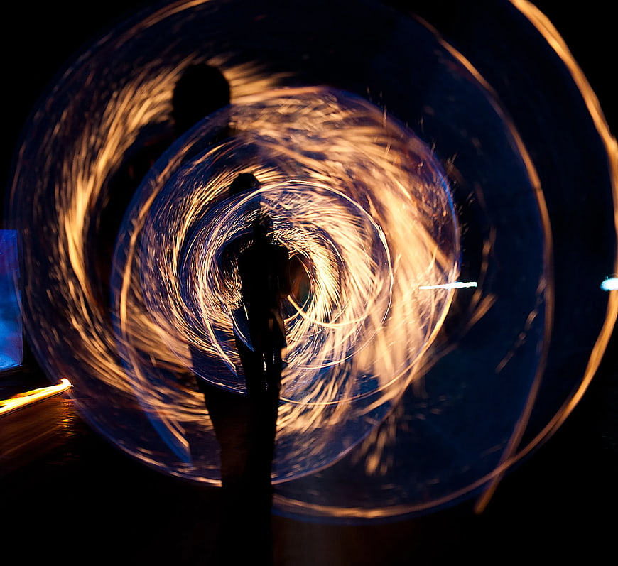 Silhouette of Person Spinning Steel Wool Fire at Night