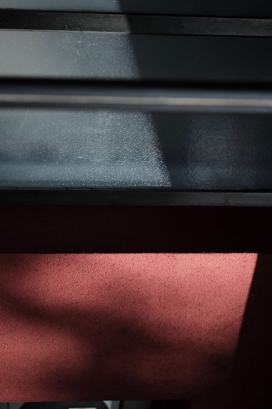 Abstract architectural detail with red wall and window shadow