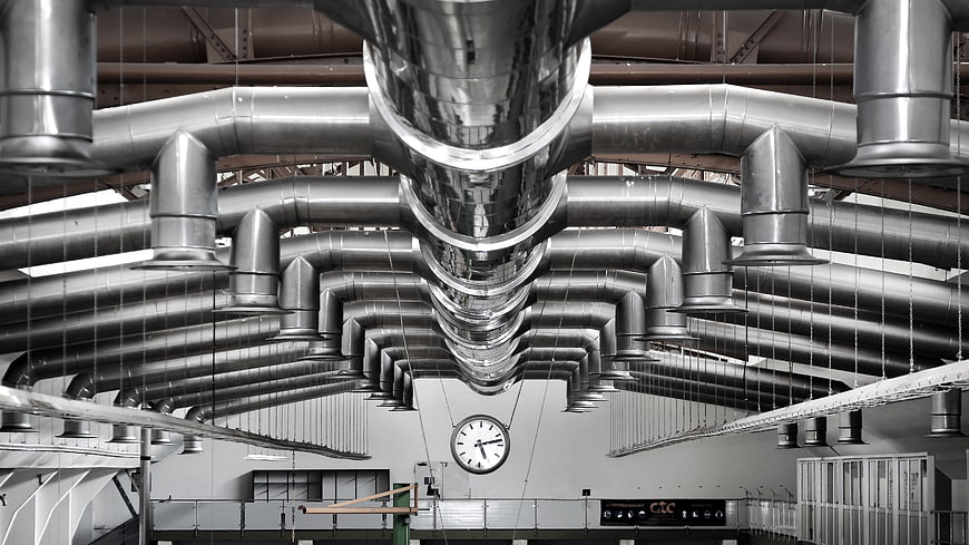 Symmetrical industrial ventilation ducts in a factory hall