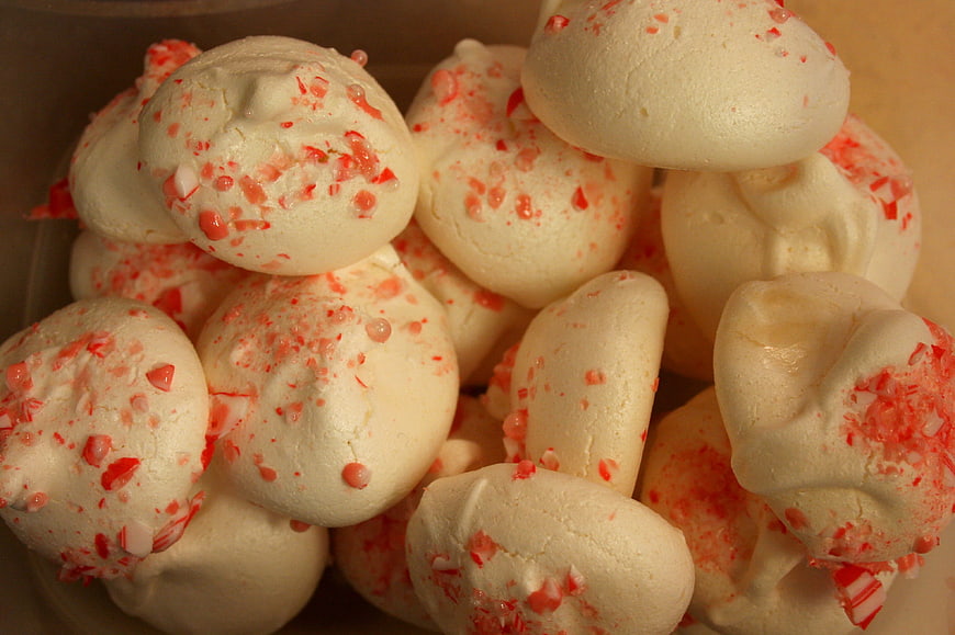 Close-up of peppermint meringue cookies with candy cane sprinkles