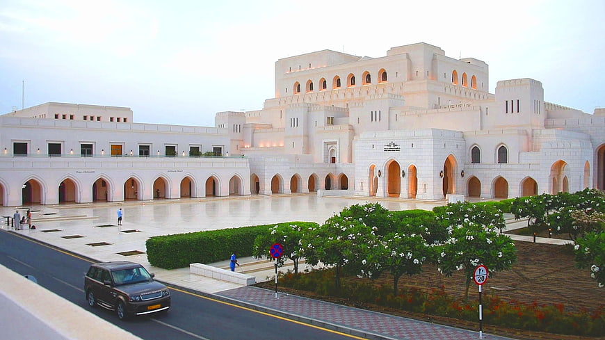 Grand white traditional architecture with arched courtyard and landscaping