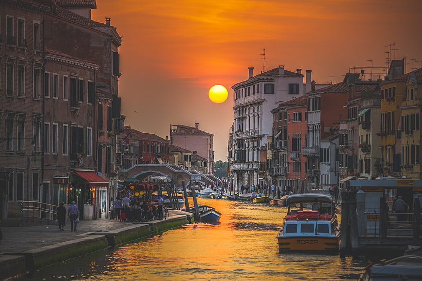 Venice Canal Sunset with Water Taxi and Historic Buildings