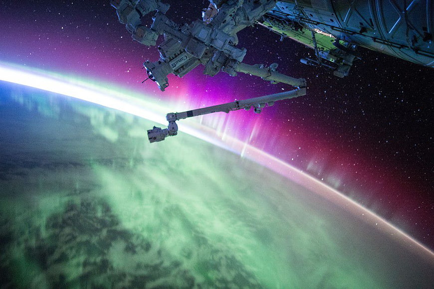 International Space Station Orbiting Earth with Aurora Borealis