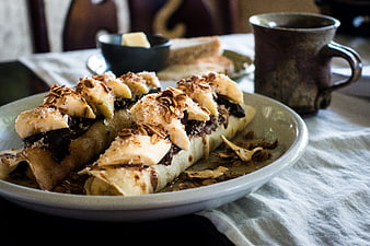 Close-up of rolled pancakes with banana, oats, and chocolate