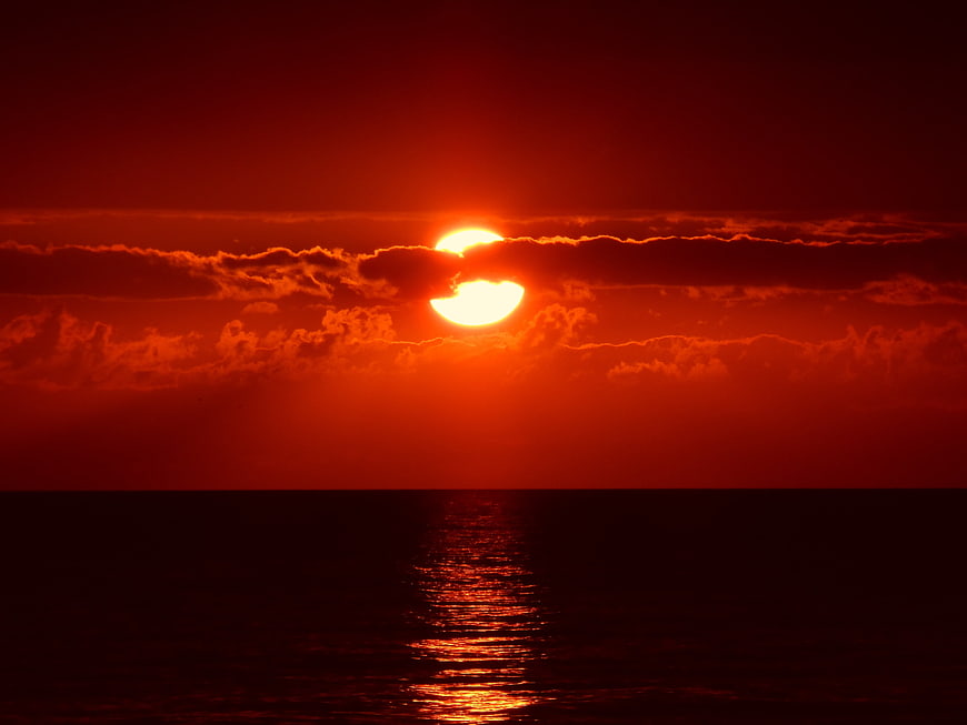Dramatic Red Sunset Over Ocean Horizon