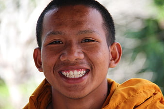 Smiling Buddhist Monk Portrait in Orange Robe