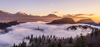 Panoramic View of Church Tower Rising Above Sea of Fog