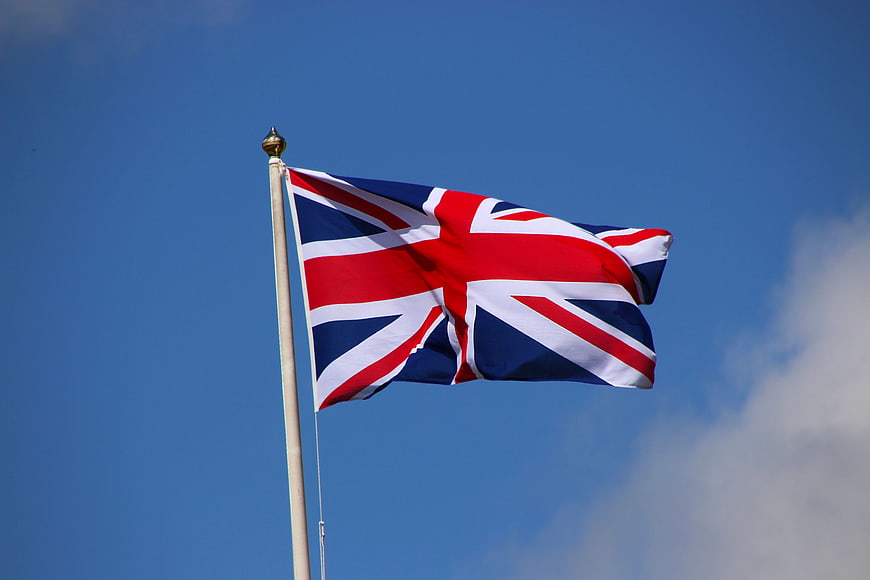 Union Jack Flag Waving Against Blue Sky