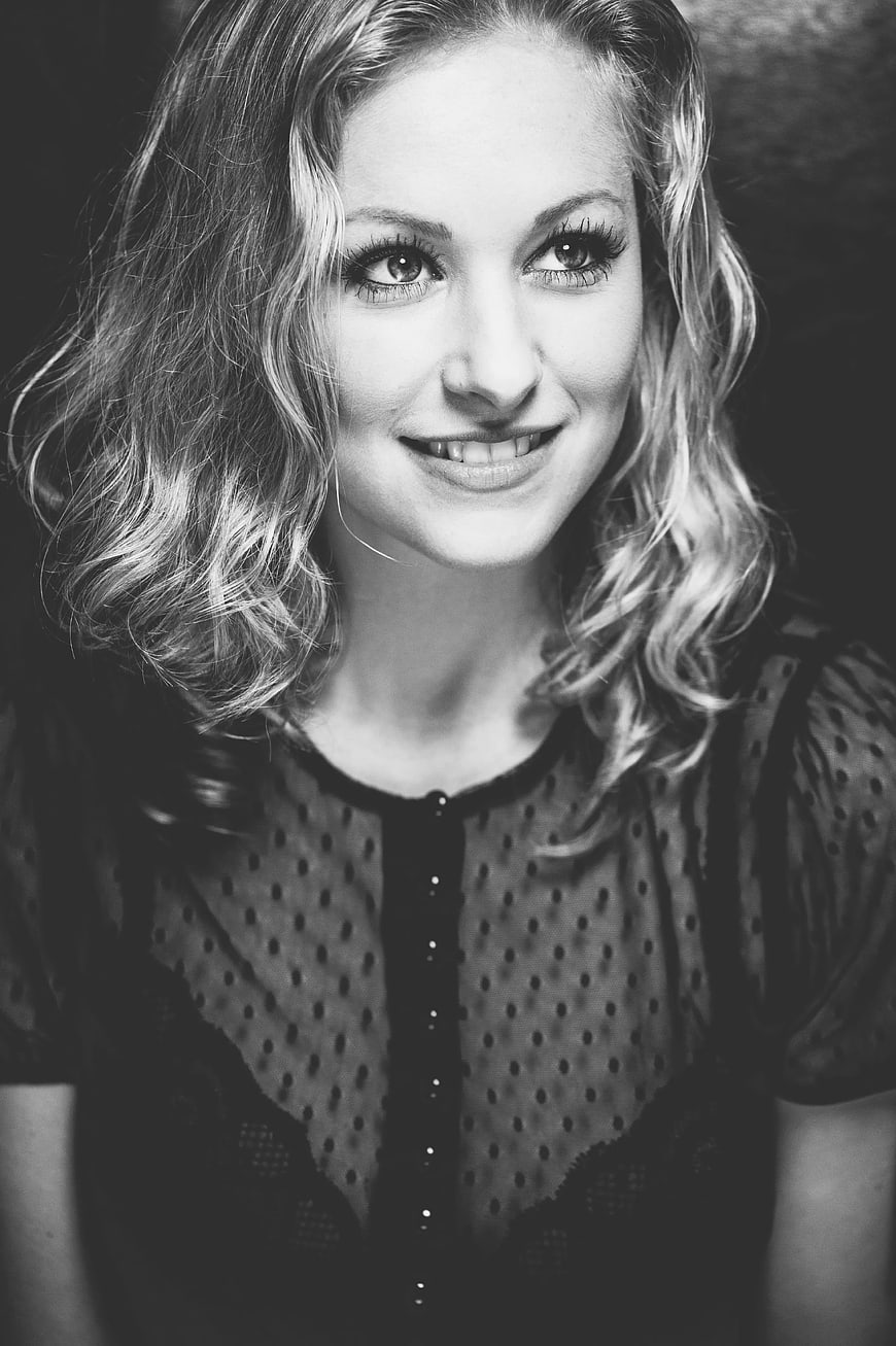 Black and white portrait of smiling woman with wavy hair