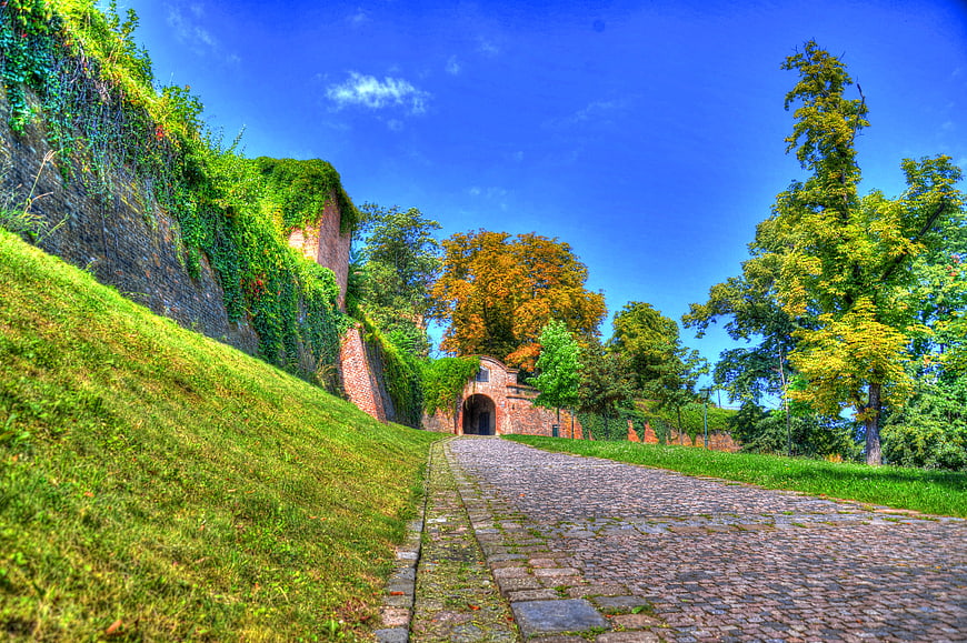 Cobblestone path leading to historic brick fortification in Brno