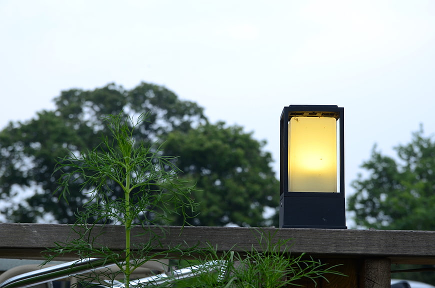 Modern Outdoor Lantern on Wooden Deck with Greenery