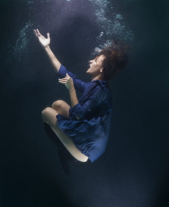 Woman Floating Underwater in Blue Dress