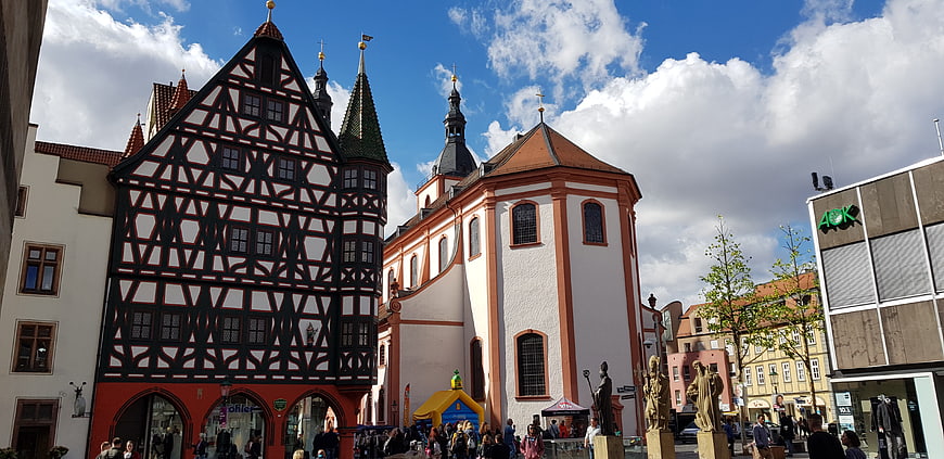 Historic Half-Timbered Building and Church in German Town Square