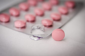 Pink Pills in Blister Pack on White Background