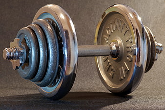 Chrome Dumbbell with Weight Plates on Dark Background
